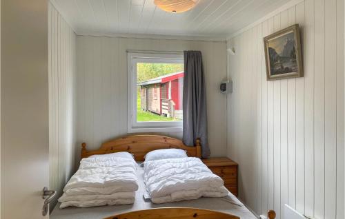 a bedroom with two beds and a window at Gorgeous Home In Grue Finnskog With Kitchen in Svullrya