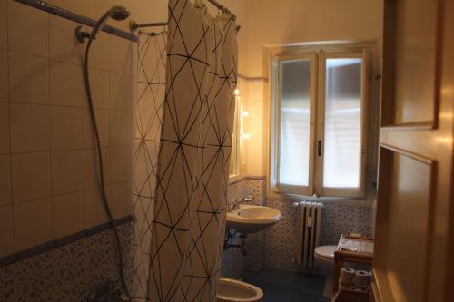 a bathroom with a shower and a sink and a toilet at Hotel Dali in Florence