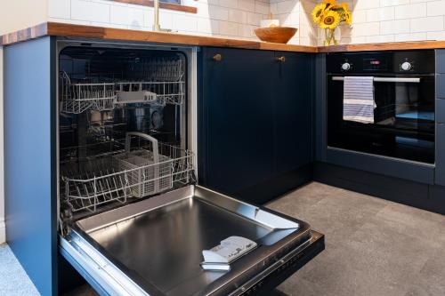 a kitchen with a sink and a dishwasher at Modern 2 Bedroom Apartment with Parking by At Hem in Southampton