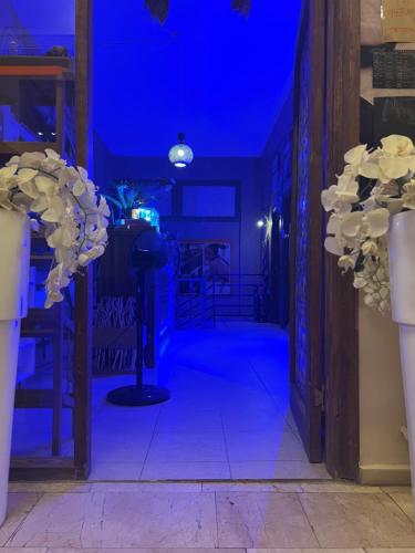 a blue room with a hallway with vases with flowers at Maximum hamam Spa in Kusadası