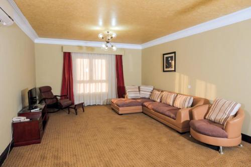 a living room with two couches and a television at The Villa 604 Powered by look in Cairo