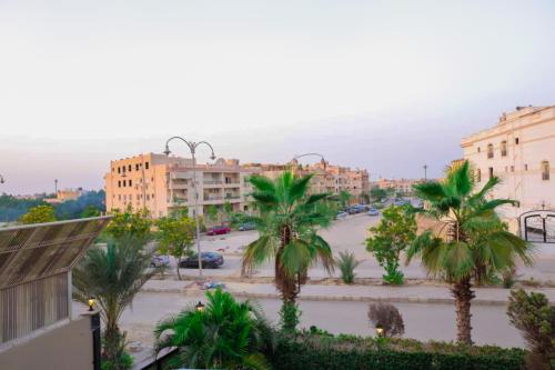 a view of a city with palm trees and buildings at The Villa 604 Powered by look in Cairo