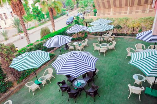 an overhead view of a patio with tables and chairs with umbrellas at The Villa 604 Powered by look in Cairo