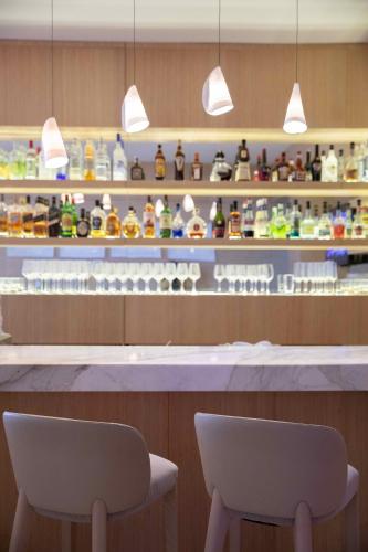 two chairs sitting in front of a counter in a store at The Grand Hotel in Punta del Este