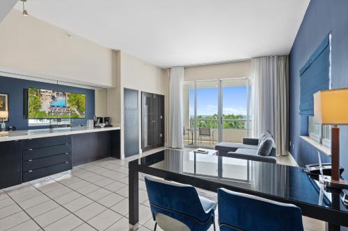 a living room with a television and a couch at The Sagamore Hotel South Beach in Miami Beach