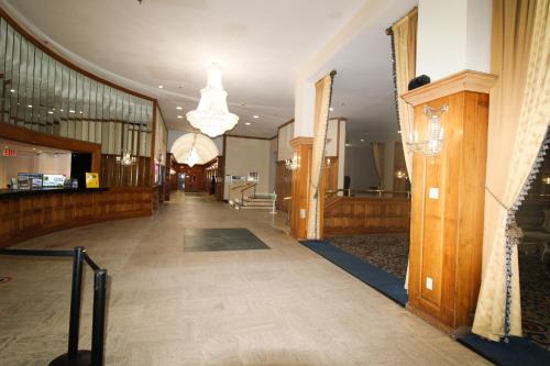 an empty hallway of a building with a chandelier at Castle 1120 Bayview Studio, Beach access, Pool, Tennis, Free parking in Miami Beach