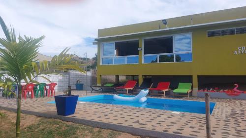 a house with a swimming pool and a playground at CHEZ ALYSSA in Nosy Be