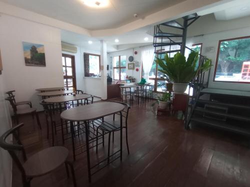 a restaurant with tables and chairs and a piano at Citywalk Hotel in Dumaguete
