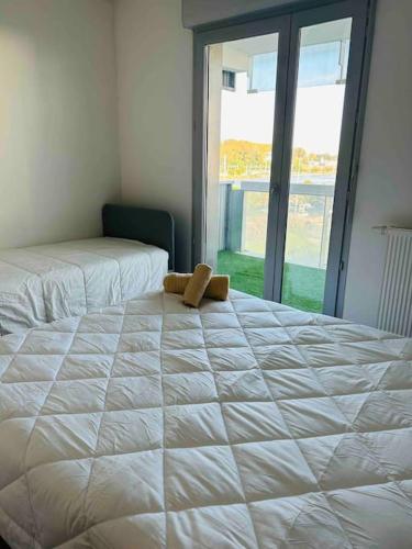 a teddy bear sitting on top of a bed at Appartement T2 + parking privatif - Centre ville in Bayonne