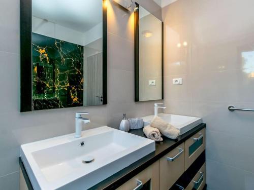 a bathroom with a white sink and a mirror at House Antonia by IstriaLux in Svetvinčenat