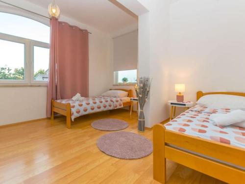 a bedroom with two beds and a large window at House Antonia by IstriaLux in Svetvinčenat