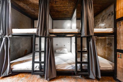 a group of bunk beds in a room at Mad Monkey Hostel Siargao in General Luna