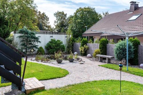 a backyard with a garden with a stone walkway at Haus Berger in Wehr