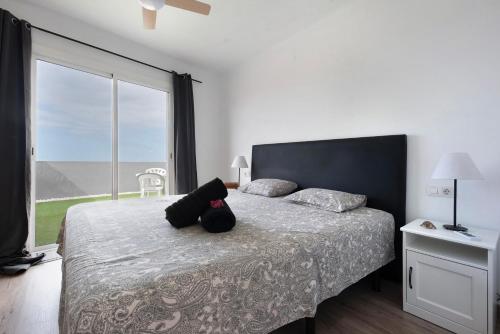 a bedroom with a bed with a teddy bear on it at Ático La Dehesa in Puerto de la Cruz