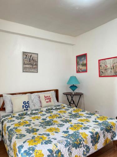 Treasure Beach Resort في Carles: غرفة نوم مع سرير مع لحاف ملون