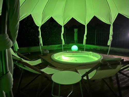 a table with chairs and a tub in a tent at VILLA PATTY ASSISI con SPA in Assisi