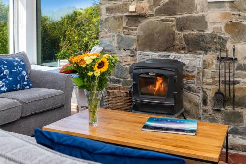 a fireplace in a living room with a coffee table with a fireplace at Cottage 435 - Clifden in Clifden