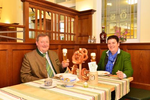 two people sitting at a table in a restaurant at Autenrieder Brauereigasthof in Ichenhausen
