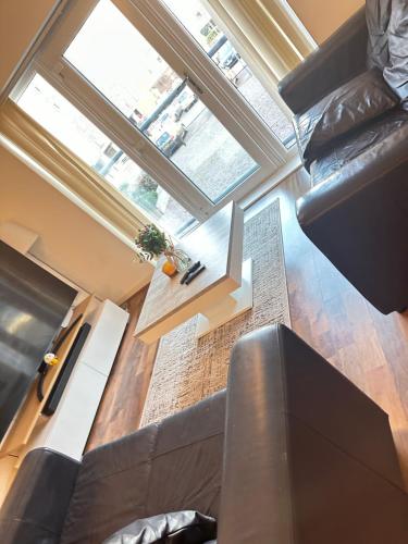 a living room with a couch and a window at Unparalleled convenience! Luxury in Manchester
