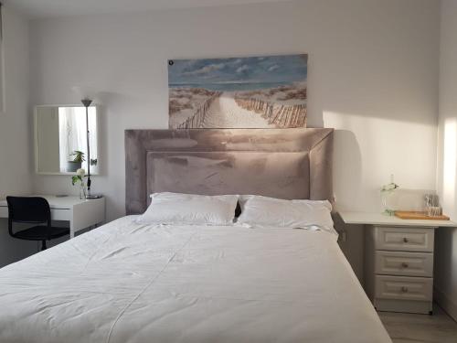 a bedroom with a large white bed and a desk at Barnoaks House - Private Room Ensuite Bathroom HomeStay in Dublin