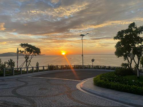 a road with a sunset in the background at Mandala Muine M2012A in Phan Thiet