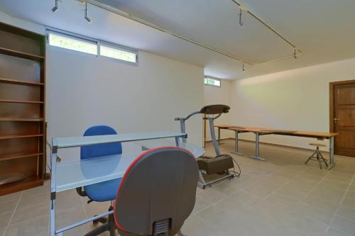 a room with chairs and a table and a desk at Daru Dunya in Beniarbeig