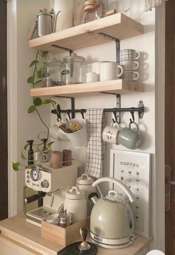 a kitchen shelf with pots and pans and a tea kettle at Ev kira in Beylikduzu
