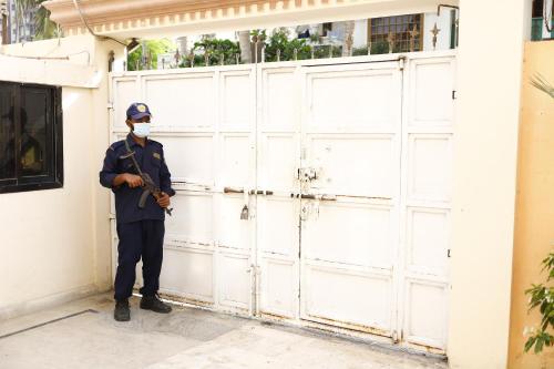 a police officer standing in front of a garage at Waypoint Hotel in Karachi