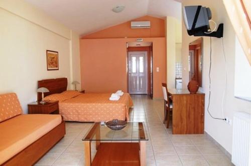 pokój hotelowy z 2 łóżkami i kanapą w obiekcie Niriides w mieście Kyparissia