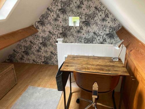 a room with a desk with a chair and a wall at The Hideaway at Peacock Farm in Bottesford