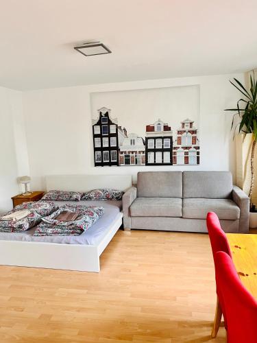 a living room with a bed and a couch at Ferienwohnung in Rheinnähe in Rheinbreitbach