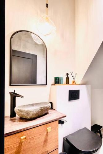 a bathroom with a sink on a counter next to a refrigerator at Modern Villa By The Sea in Palanga