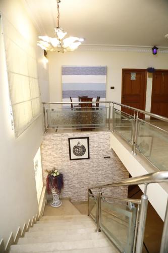 a staircase in a building with a table and a vase at Waypoint Hotel in Karachi