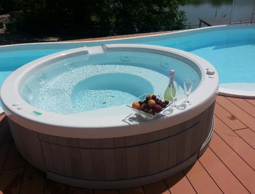 a circular pool with a bowl of fruit and wine glasses at Villaggio La Pescaccia in San Clemente