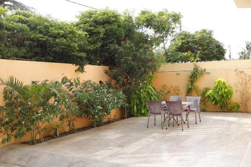 a patio with chairs and a table in front of a fence at Waypoint Hotel in Karachi