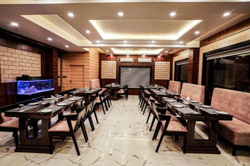 a conference room with tables and chairs and a projection screen at Gogol Beach Resort !! Beach 1 Minute !! in Mandarmoni