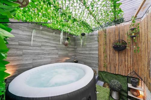 a garden with a hot tub in a backyard at Luxe Coastal Retreat w/ Hot Tub in Ramsgate