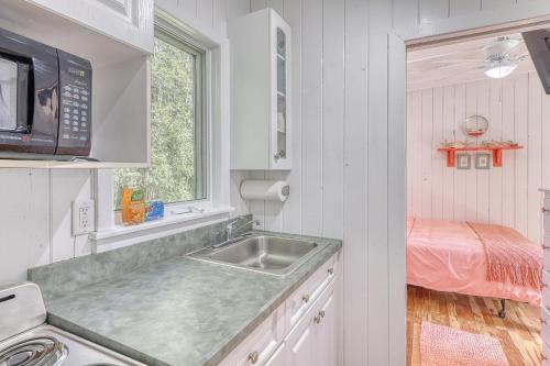 a kitchen with a sink and a microwave at The Surfcomber Multi-Residence Home in Ocean Bay Park