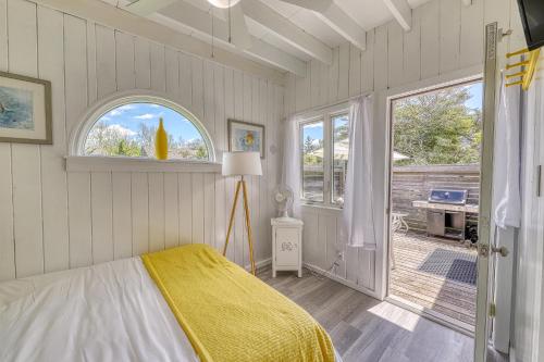 a bedroom with a bed and a window and a patio at The Surfcomber Multi-Residence Home in Ocean Bay Park