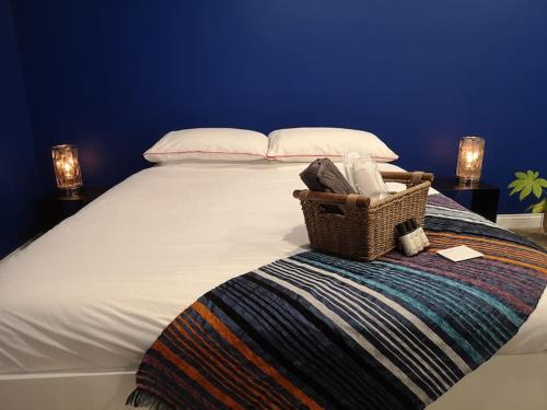 a large bed with a basket on top of it at Tranquil Country Escape West Coast Adventure Awaits in Galway