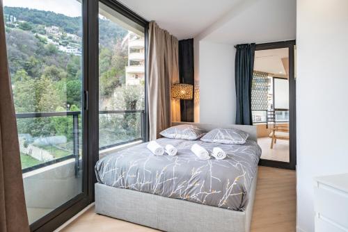 - une chambre avec un lit et une grande fenêtre dans l'établissement Monaco Border, sea view, Parking, à Beausoleil