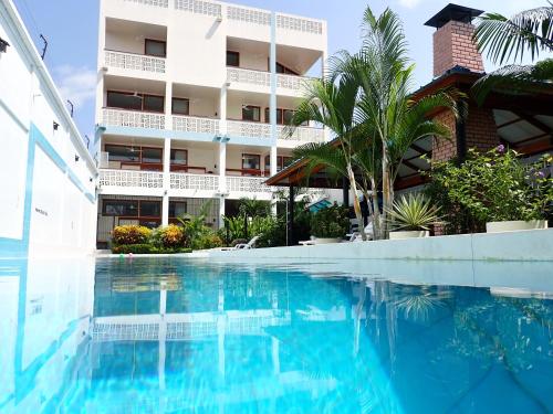 a swimming pool in front of a building at Morona Flats & Pool - 70 m2 in Iquitos