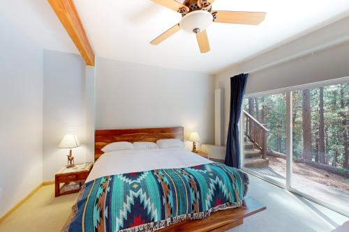 a bedroom with a bed and a ceiling fan at Fawn Voyage in Portola