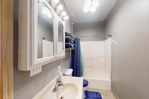 a bathroom with a sink and a toilet and a mirror at Fawn Voyage in Portola