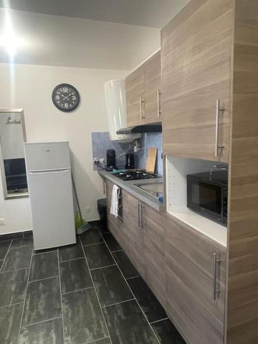 Il comprend une cuisine équipée d'un réfrigérateur et d'une cuisinière. four supérieur dans l'établissement L8 - Villiers-le-Bel proche ROISSY & PARIS, à Villiers-le-Bel