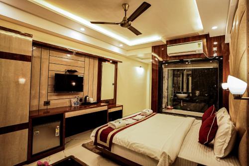 a bedroom with a bed and a television in it at Gogol Beach Resort !! Beach 1 Minute !! in Mandarmoni