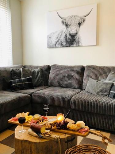 a living room with a couch and a table with food at Puur Mechelen in Mechelen