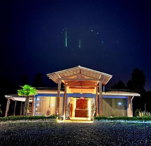 a house with a lit up facade at night at Espaço Vento Solar in São Roque