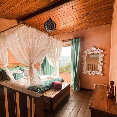 a bedroom with a canopy bed with a window at Espaço Vento Solar in São Roque