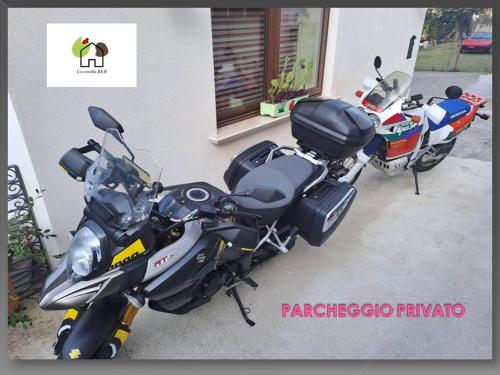 two motorcycles parked in front of a building at Coccinella B&B a Tufo in Tufo